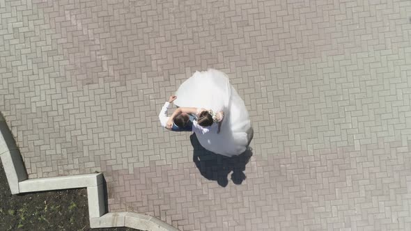 Aerial view of wedding couple dancing in a park 22