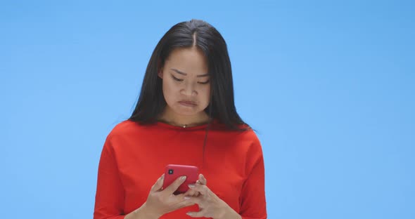 Young Woman Chatting on Smartphone