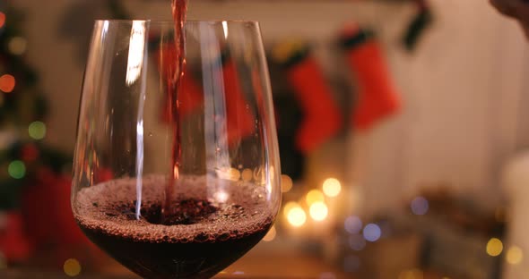 Red wine pouring into glass