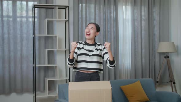 Happy Young Asian Woman Celebrating Finish Carrying Cardboard Box With Stuff Into A New House