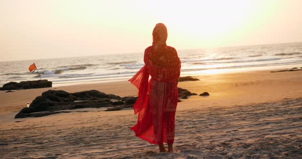 Young Women Wearing a Red Saree on the Beach Goa India