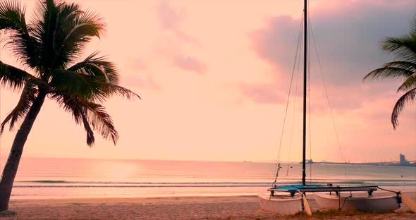 Beautiful Sunset in the Tropics on the Backdrop of the Ailboat on the Sand and Ocean. Concept Nature