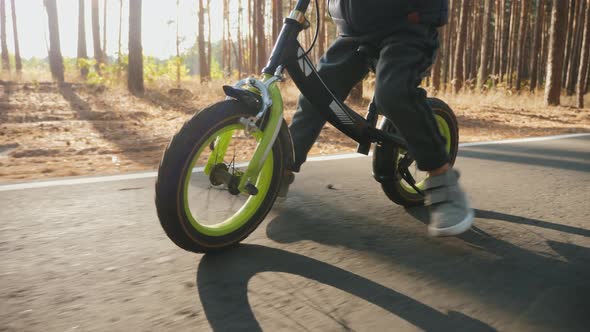 A Little Boy Rides on the Balance Bike, Close Up