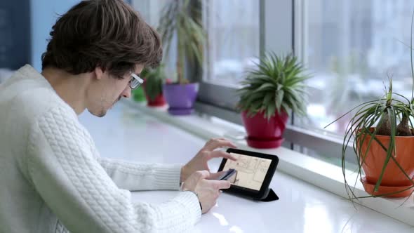 Engineer designer works with drawings on a tablet in the office.