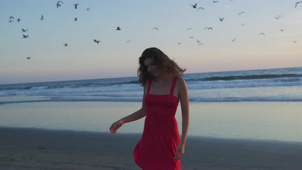 Grateful girl on Santa Monica beach, at sunset