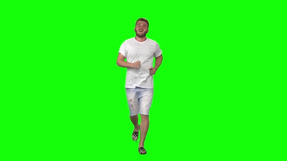Bearded Guy Calmly Is Running on Green Screen Background. Chroma Key. Front View. Slow Motion