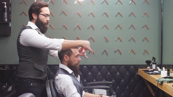 Skillful Barber. Young Man Getting an Old-fashioned Shave with Straight Razor