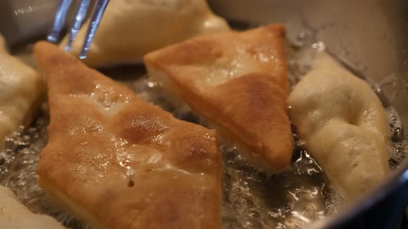 Fried buns in hot oil tasty popular snack 3840X2160 UltraHD footage - Close-up pirozhki made of doug