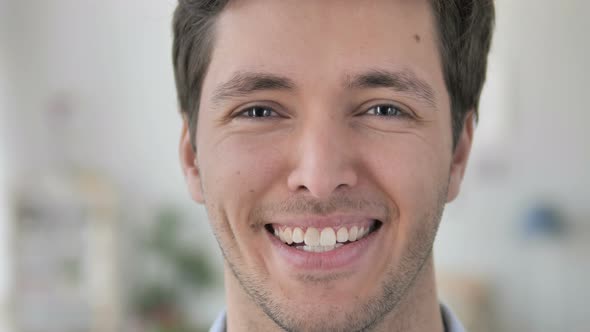 Face Close Up of Smiling Handsome Young Man