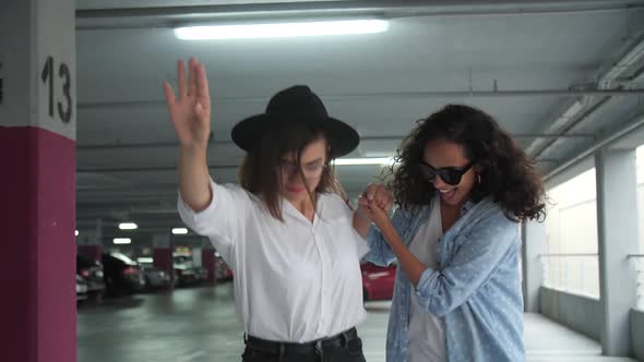 Happy Women Having Fun And Skateboarding At Parking