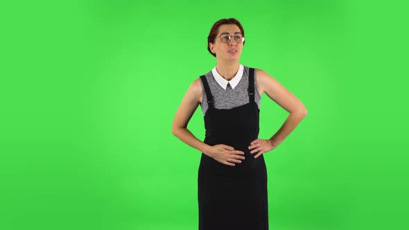 Funny Girl in Round Glasses Is Feeling Very Bad, Her Stomach Hurting. Green Screen