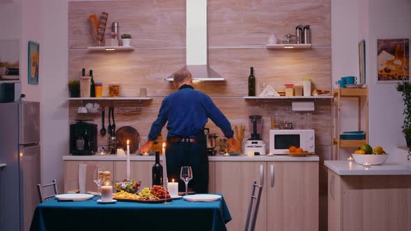 Old Man Cooking for His Wife