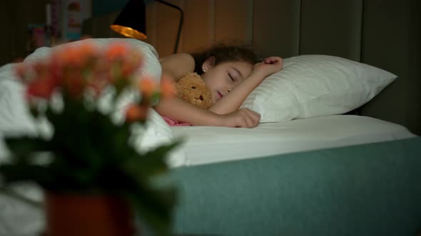 Sleeping Toddler Child Little Girl Happy and Carefree in Bed Hugging Teddy Bear Toy