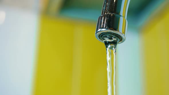 Water Flows From a Tap Into a Sink