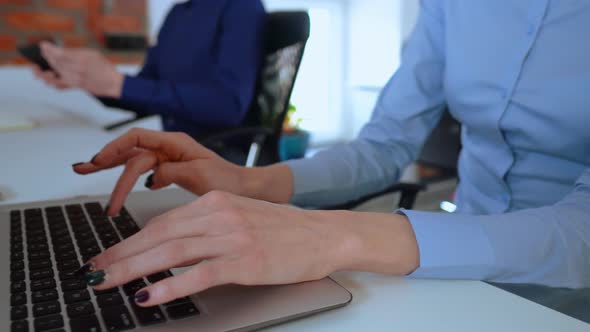 Close Up Two Young Employees in Startup Company