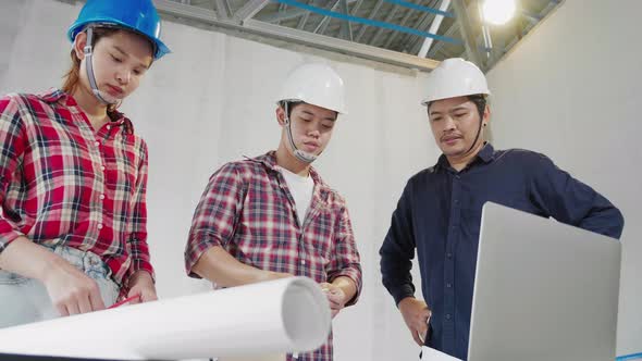 Three construction engineer team meeting together in real estate building in safety Uniform.