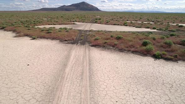 Flying over tire tracks through desert terrain in Utah