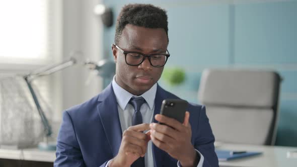 Portrait of African Businessman Using Smartphone