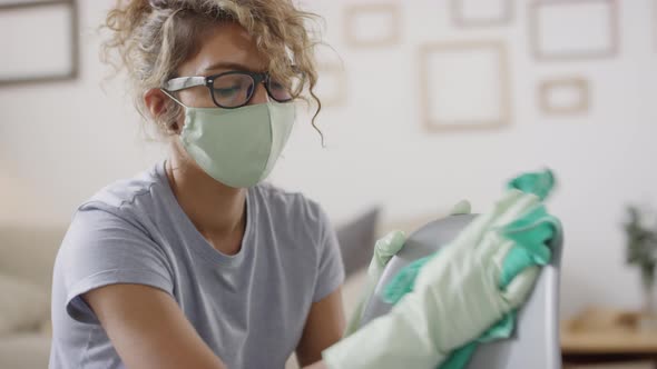 Woman in Face Mask Disinfecting Chair