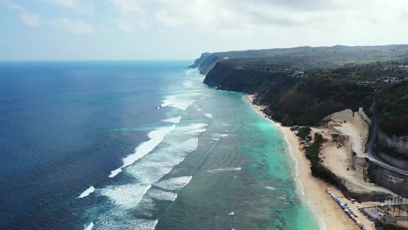 waves washing on the white sand beach on the paradise island with stone quarry and beautiful clifs,