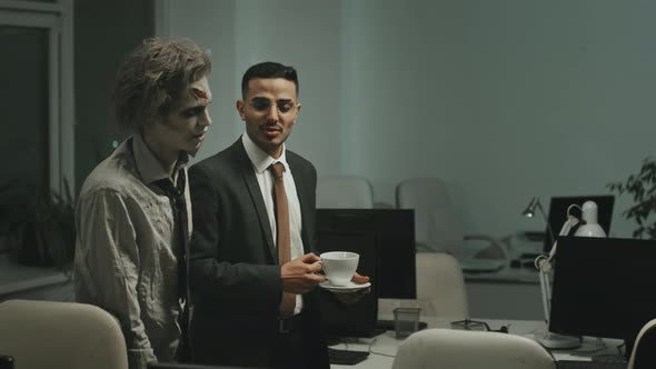 Successful Businessman Talking to Zombie Office Worker