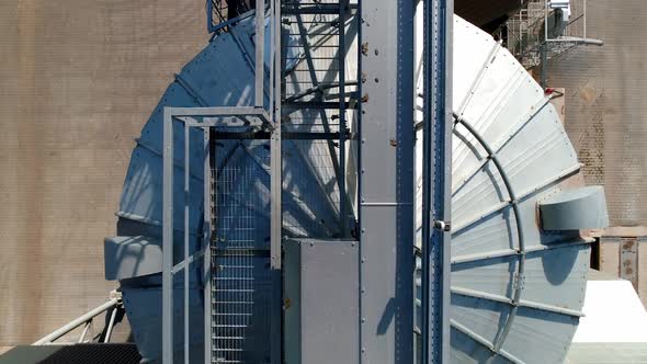 Silver bins for storing crop. Industrial granary on field. View from above on aluminum containers.