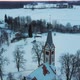 Aerial Top View of the Krimulda Evangelic Lutheran Church in Winter at Sunrise Latvia 4k Video - VideoHive Item for Sale