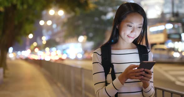 Young woman use of smart phone in city