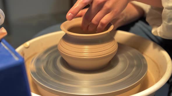 Woman Makes a Pot on a Pottery Wheel in a Workshop, Slow Motion