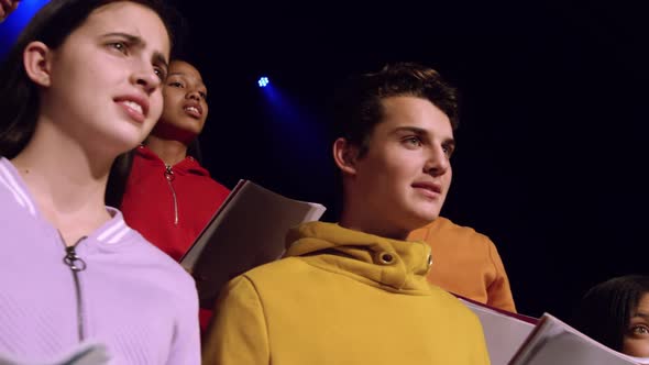 Teenagers rehearsing in a theatre