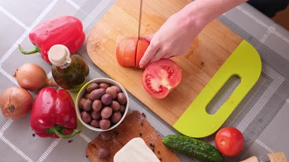 Greek Salad Preparation Series Concept  Woman Cutting Tomatoes