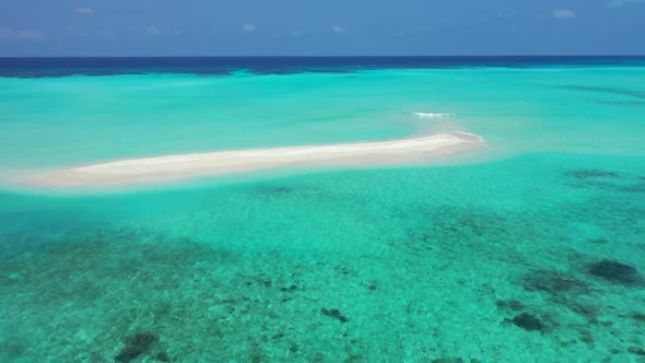 Aerial top down sky of perfect island beach voyage by transparent lagoon with clean sandy background