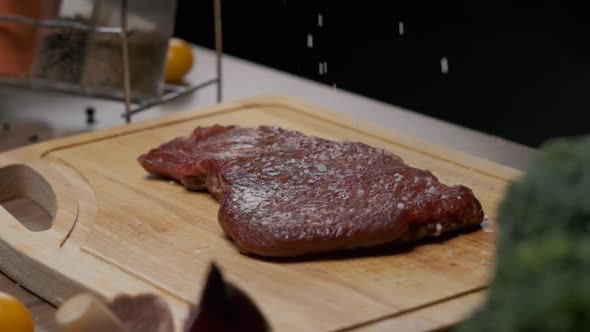 Professional Chef Salting Meat Steak