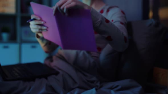 Student Girl with Notebook and Laptop at Night