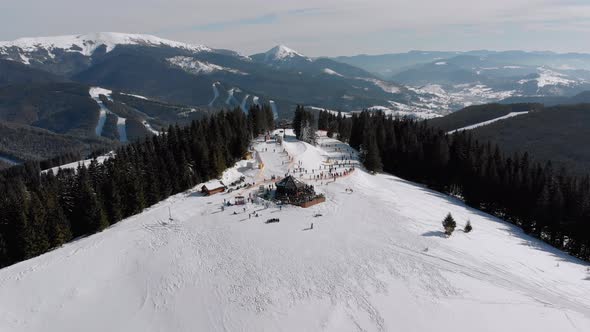 Aerial Ski Slopes with Skiers and Ski Lifts on Ski Resort, Snowy Mountain Forest