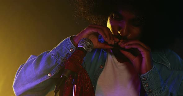 Man playing harmonica at nightclub 4k