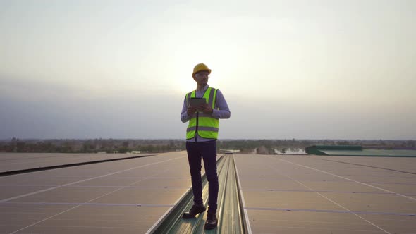 Portrait of engineer man or worker, people, working on solar panels or solar cells on the roof