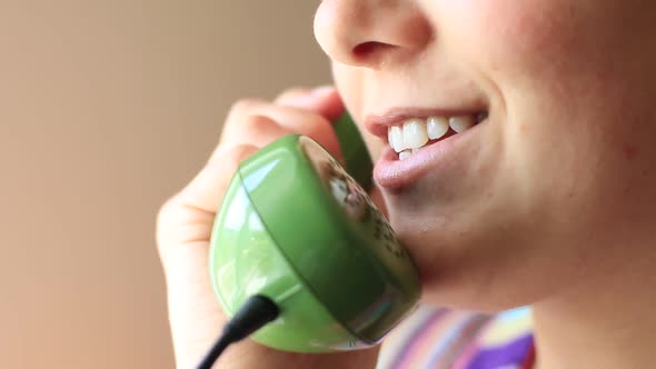 Woman Talking On Landline Phone