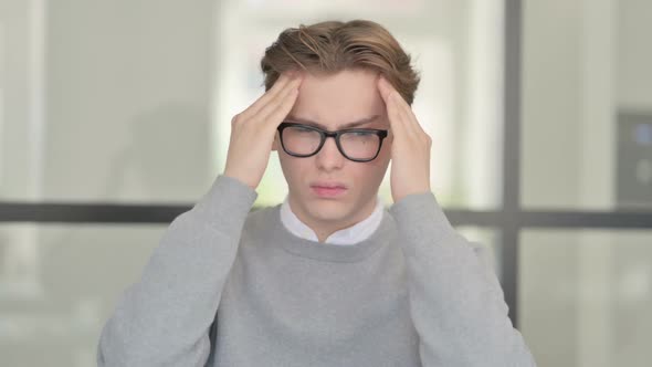 Portrait of Young Man Having Headache