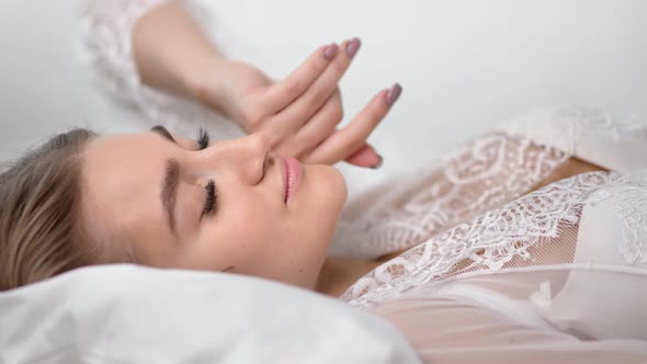 Close Up Face of Attractive Morning Woman Waking Up Stretching in Bed