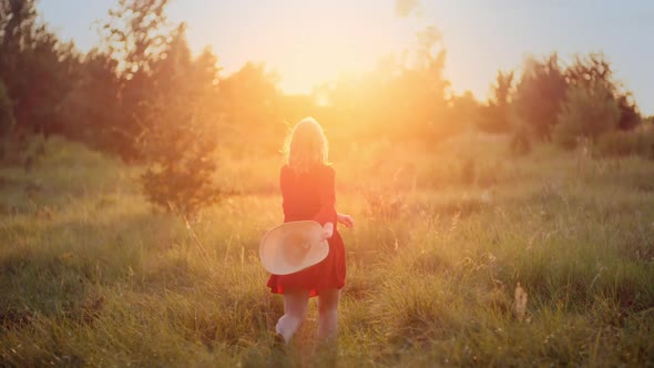 Portrait of Positive Smiling Woman Looking Into Camera at Sunset