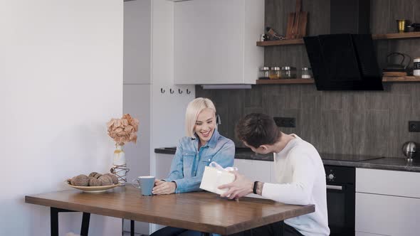 Young Attractive Guy Giving His Girlfriend a Gift