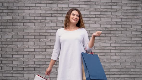 A Girl with Packages After Shopping with a Good Mood