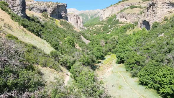 Ascending aerial view of a rugged canyon in a Rocky Mountain wilderness area