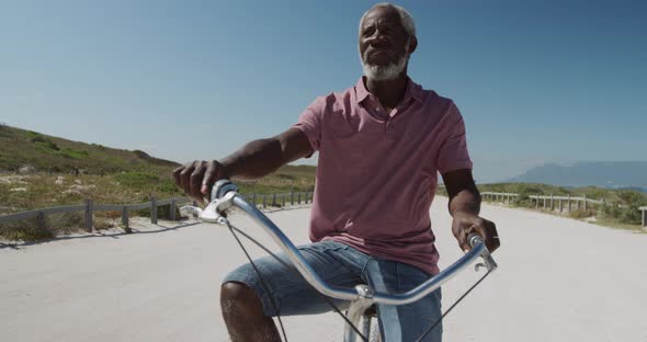 Senior man on a bike near the beach