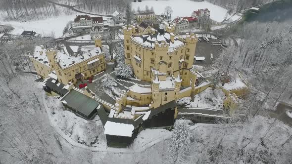 Aerial View Of Hohenschwangau flying to top of the castle in winter