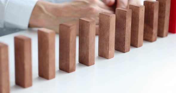 Person Was Unable to Stop Falling Wooden Blocks Closeup