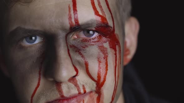 Halloween Man Portrait. Guy with Dripping Blood on His Face. Scary Makeup