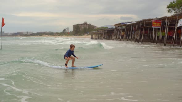 Surf Instructor Teaches Little Boy How To Surf