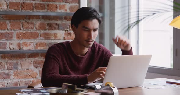 Mixed race man concentrated and working in his house